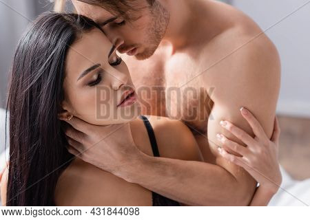 Passionate Man Touching Neck Of Seductive Woman In Black Underwear