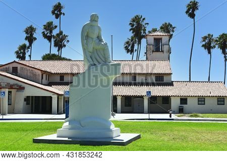 SAN PEDRO, CALIFORNIA - 27 AUG 2021: Juan Rodriguez Cabrillo Statue and the Bathhouse at Cabrillo Beach.
