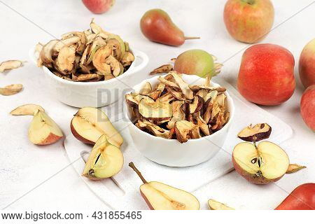 Homemade Apple Chips In A Cup With Apples On A White Background, In Autumn Apples Are Baked In The O