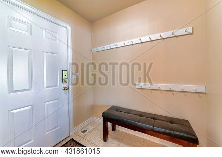 Front Door Interior With Bench And Hooks On The Side