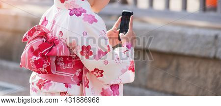 Woman Tourist Wearing Kimono Take A Photo By Mobile Smartphone In Kiyomizu Dera Temple, Kyoto, Japan