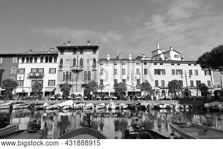 Desenzano, Italy - October 8:  The View Across Boats Moored In The Resort Town Of Desenzano To Cafes