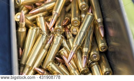 Pano Loads Of Long Sharp Bullets Inside Its Case With A Blue Cloth On The Side.