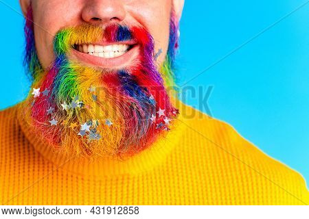 Handsome Man With Raindow In Beard With Glitter Confetti In Blue Studio Baclground