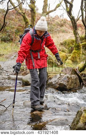 Asian Indian Woman Hiker In Waterproof Clothing, Hiking In Gwydyr Forest, Snowdonia, Wales, Uk