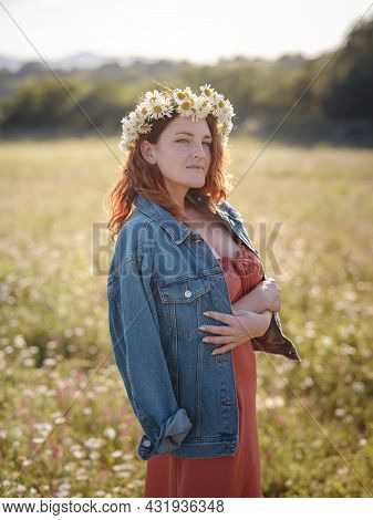 Red-haired Woman On Field On Summer Evening
