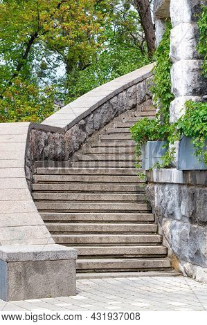 A Stone Staircase With Massive Steps Climbs Around The Old Wall Of The Ancient Castle Against The Ba