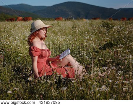 Red-haired Woman On Field Summer Evening