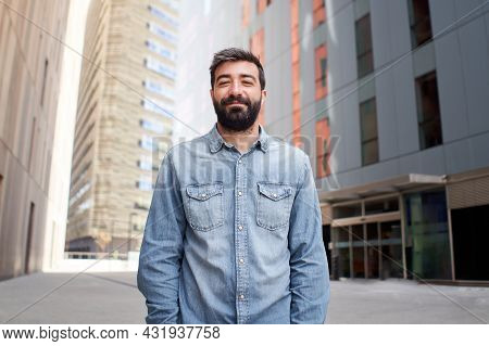 Attractive Business Man Looking At Camera Outdoors Near Large Office Building. Young Casual Dressed 