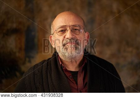 Portrait Of A Middle-aged Caucasian Man Looking At Smiling Camera. Look Of An Older Person Indoors.