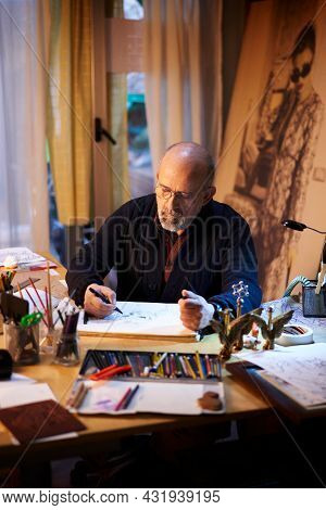 Artist Working In The Studio. Middle-aged Man Making Creative Artwork.