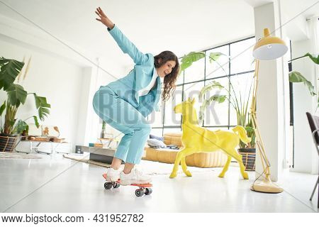 Business Woman Riding Skateboard Dressed In Office Worker Outfit At Home. Office Worker Taking A Bre