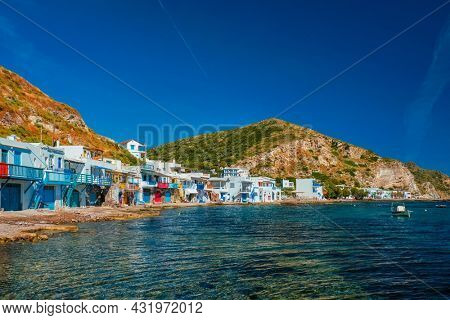 Scenic picturesque greek fishing village Klima with whitewashed traditional houses and colorful windows and doors on Milos island in Greece