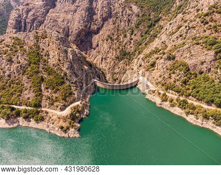 Aerial View Of The Dam Wall At Lac De Tolla And The Surronding Mountains In Corsica