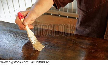 Hand Varnishing The Wooden Surface Of The Product With A Small Brush, Applying A Protective Varnish 