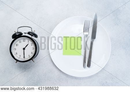Intermitted Farsting Diet Concept - Empty Plate With Fork And Knife And Timer