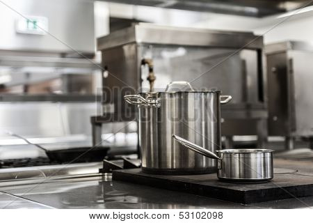 Pots standing on hotplate in professional kitchen
