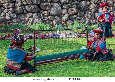 CUZCO, PERU - JULY 15: women weaving in the peruvian Andes at Cuzco Peru on july 15th, 2013. In the Andes of Peru every village has its own weaving patterns and traditions.