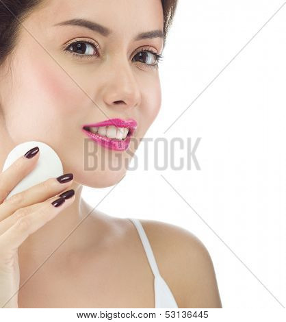 beauty portrait of attractive  caucasian smiling young woman brunette, cleaning her face; cotton disc; face care; skin; isolated on white , studio shot, toothy smile,  looking at camera; hand, 