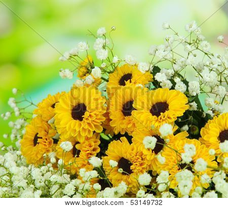 Beautiful flowers on table on bright background