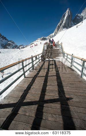 Wooden Stair And Traveler On Jade Dragon Snow Mountain,lijiang,yunan,southwestern China.