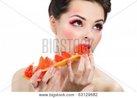Female face with pummelo slice over white background