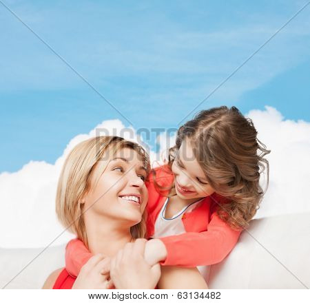 family, child and happiness concpt - hugging mother and daughter