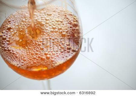 Rosa Being versé dans un verre de vin
