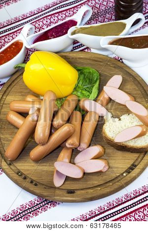 sausages on a wooden plate with vegetables in a restaurant