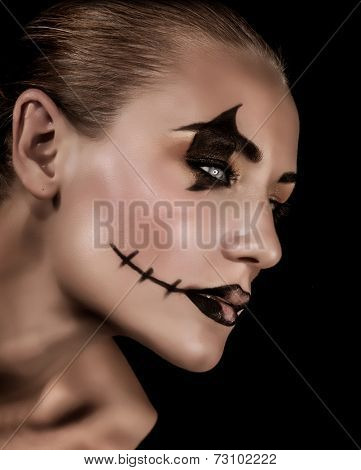 Creepy vampire portrait isolated on black background, fashionable makeup for Halloween part, horror and mystery concept