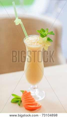 Milk cocktail with orange and carom