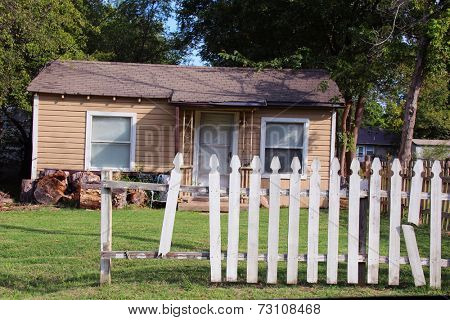 Small neglected house with a lawn