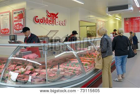 SARLAT, FRANCE - JUNE 28, 2013: People buy meat in the butcher shop Golden Beef. The shop has branches in Limoges, Brive, and Saint-Junien
