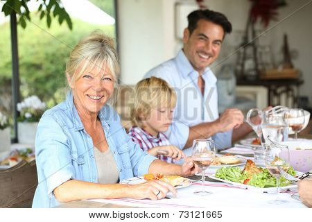 Family having summmer lunch in country house