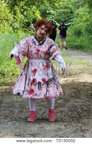 MUSKOGEE, OK - Sept. 13: A bloody male zombie waits for the next runner to chase during the Castle Zombie Run at the Castle of Muskogee in Muskogee, OK on September 13, 2014. 