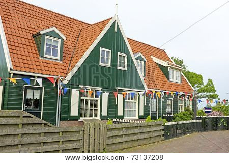 Traditional farmers house decorated with flags at kingsday in the Netherlands