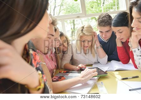 happy young teens group in school on chemisty lessons and library education