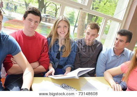 happy young teens group in school on chemisty lessons and library education