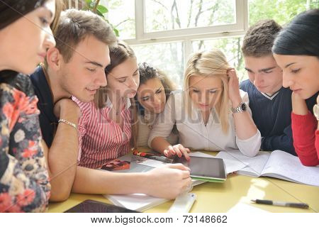 happy young teens group in school on chemisty lessons and library education