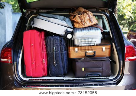 Suitcases and bags in trunk of car ready to depart for holidays