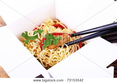 Chinese noodles in takeaway box closeup