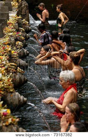 SEPTEMBER 18, 2014 - BALI, INDONESIA: Devotees bathe in the temple pool of Pura Tirta Empul in a cleansing and purification ceremony. Hinduism is the religion of the Balinese people.