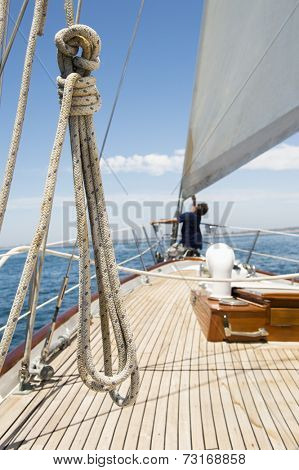 Man working on prow of yacht