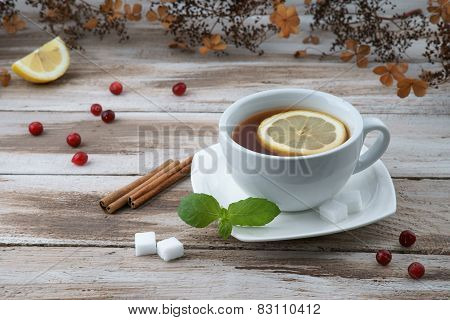 Cup of tea with cranberry and lemon piece