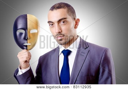 Businessman with mask in hypocrisy concept