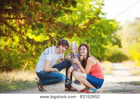 Happy young family spending time outdoor on a summer day