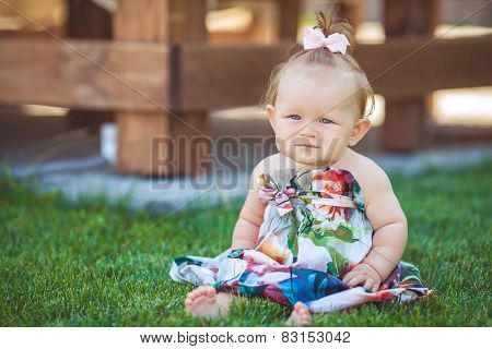 Rural girl playing alone in the street in the summer.