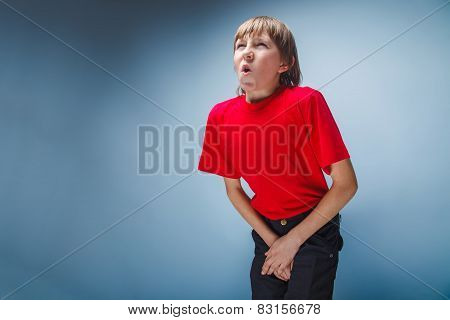 boy teenager European appearance in a red shirt holding hands in