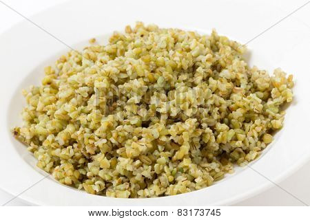A bowl of freshly boiled cracked freekeh scorched green wheat grains, one of the 