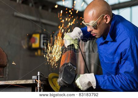 Worker Grinding Metal With Angle Gringer